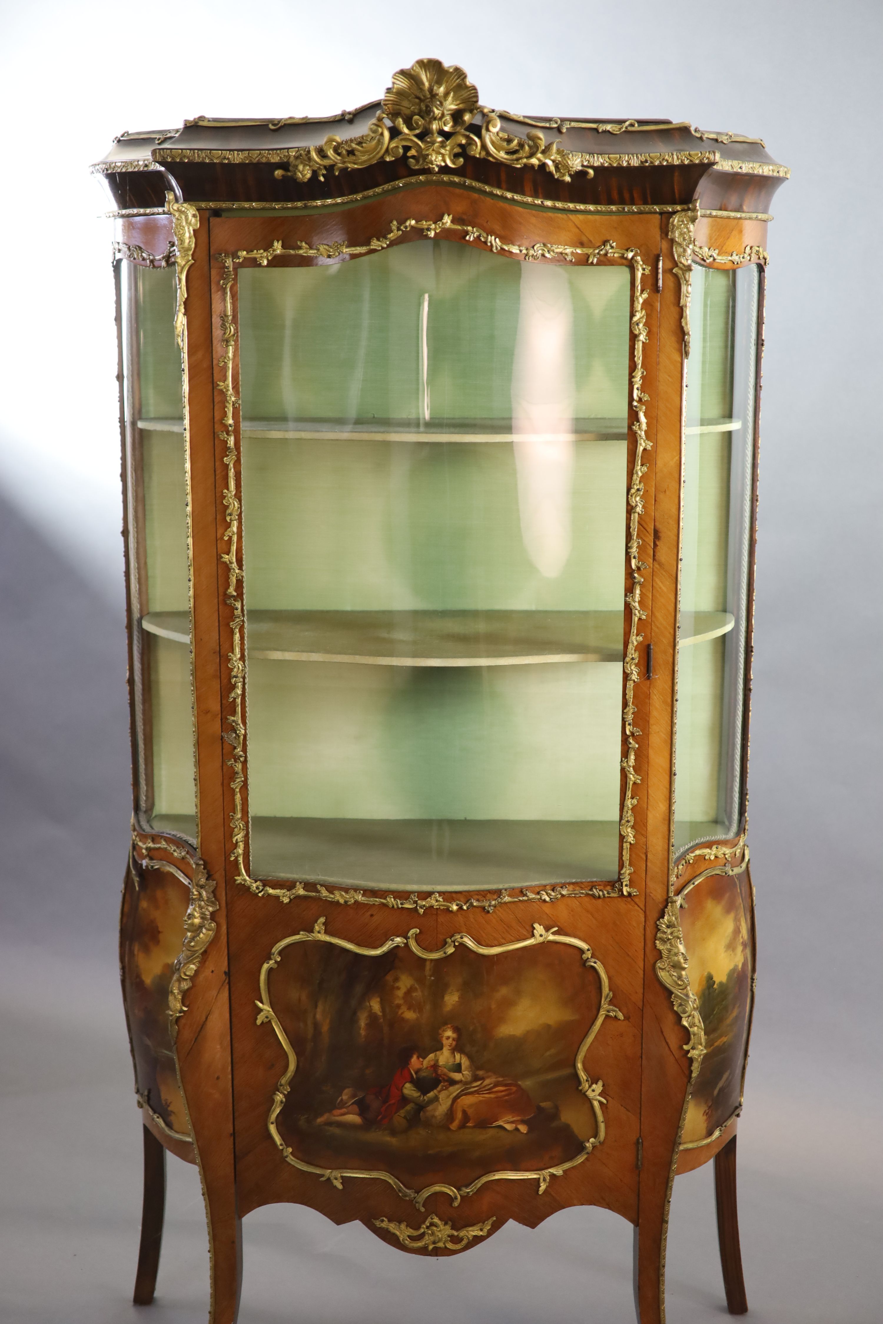 A Louis XV style mahogany vitrine, 76cm wide, 38cm deep, 194cm high.